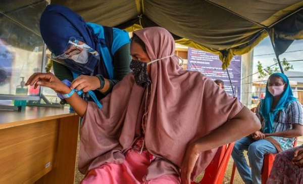 After a seven-month ordeal at sea, a Rohingya refugee is registered at a site in Aceh province, Indonesia.