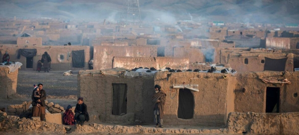 Smoke rises from the chimneys of houses in a camp for displaced people during a harsh winter in Afghanistan.

