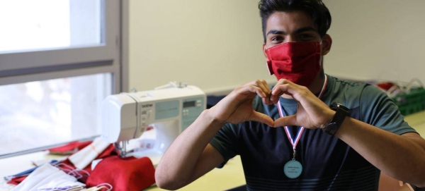 A 23-year-old Afghan refugee has stitched over 700 protective masks during the COVID-19 crisis to help support his new community in France.
