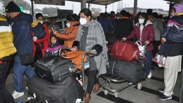 Passengers arriving from Italy exit the arrival section of the airport after their Covid-19 coronavirus screening at Sri Guru Ram Dass Jee International Airport in Amritsar, India, on Jan. 6.
