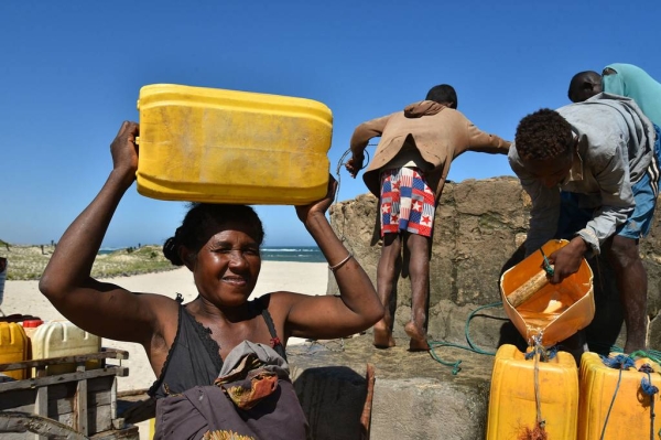 People draw water from a well built on Faux Cap's beach in Madagascar.