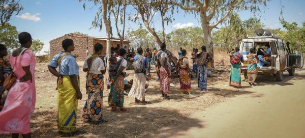 Women queue to receive their COVID-19 vaccine in Malawi.