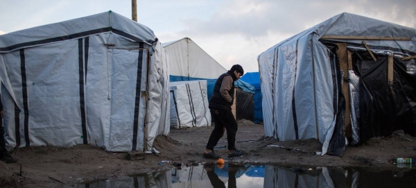 A boy walks through a migrant camp in Calais, northern France, hoping to enter the United Kingdom. (file)
