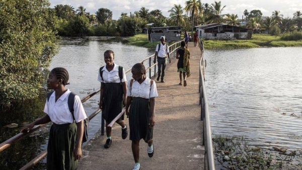 Girls coming home from a school in Liberia. Many girls are unlikely to return to school after the pandemic, according to Oxfam.
