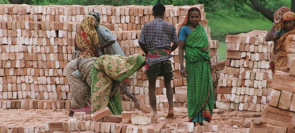 Workers stack bricks at a factory near Dhaka in Bangladesh.