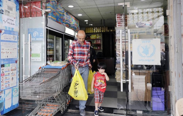A Syrian refugee shops at a store, which accepts the United Nations' World Food Program electronic cards, in Beirut. — File photo