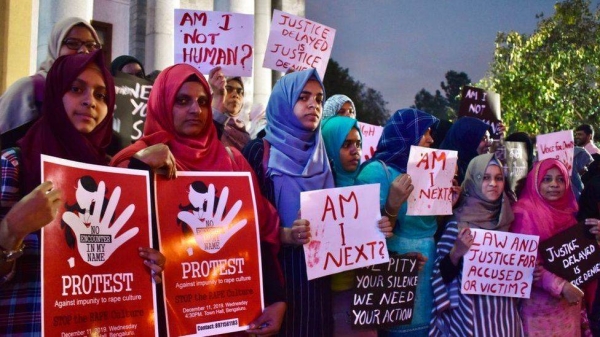 Activists from various women's rights organizations hold placards as they protest against sexual harassment, rapes and murders of women across the country urging the government to help uphold the women's rights, during a demonstration in Bangalore on December 11, 2019.
