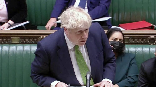British Premier Boris Johnson answers a question during Wednesday's raucous Prime Minister's Questions amid a parties scandal that threatens the PM's leadership.