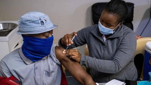 A patient gets vaccinated against COVID-19 at the Witkoppen clinic in Johannesburg on December 8, 2021.