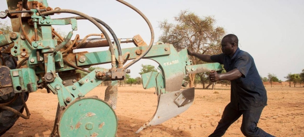 Workers preparing tractors to start plowing in Burkina Faso.
