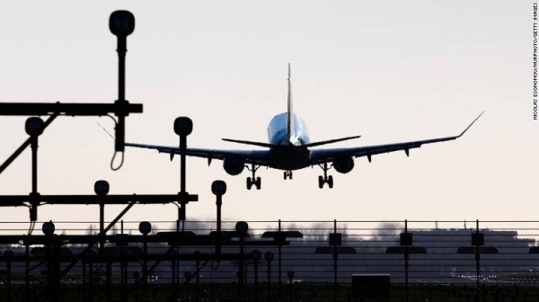 Rear view of various aircraft landing behind the runway lights in Amsterdam Schiphol International Airport in the Netherlands.
