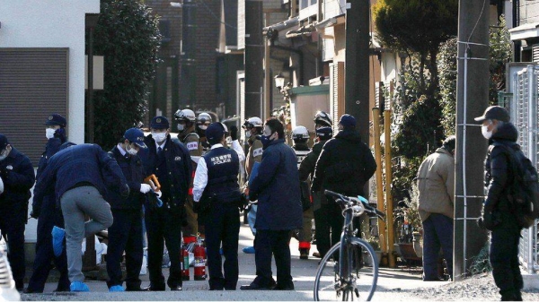 Police and other responders outside the suspect's home on Friday.