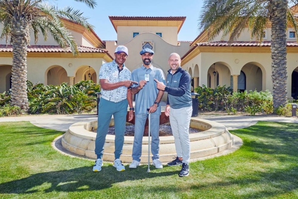 Amer Al Rumaih (center) poses with his EDGA membership card.