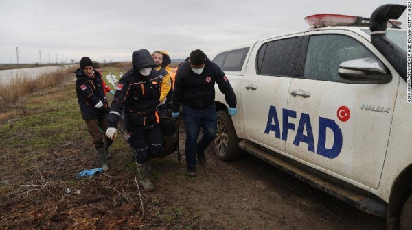 Turkish officials carry the bodies of people found frozen to death in Ipsala, close to the Greek border, on February 2.