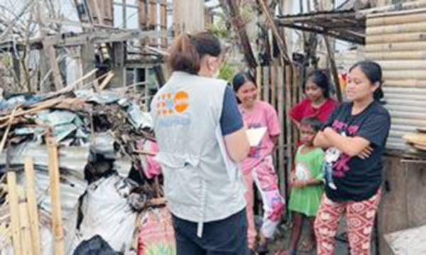 A UNFPA staff member walks to a damaged health center in General Santos on the island of Mindanao in the Philippines. — courtesy UNFPA Philippines