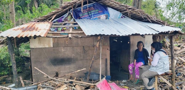 A UNFPA staff member walks to a damaged health center in General Santos on the island of Mindanao in the Philippines. — courtesy UNFPA Philippines
