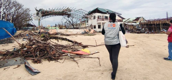 A UNFPA staff member walks to a damaged health center in General Santos on the island of Mindanao in the Philippines. — courtesy UNFPA Philippines