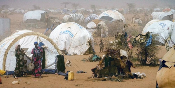 File photo shows Somali women and children standing outside temporary tents in the Dagahaley refugee camp near the Kenya-Somalia border. — courtesy UNICEF/Kate Holt