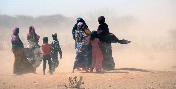 File photo shows Somali women and children standing outside temporary tents in the Dagahaley refugee camp near the Kenya-Somalia border. — courtesy UNICEF/Kate Holt