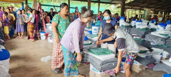 Internally displaced people receive assistance at the Myaing Gyi Ngu camp in Myanmar’s Kayin State. — courtesy UNHCR/Sa Nyein Chan