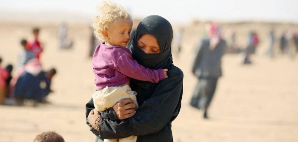 A family receives clothes for the winter from UNICEF in Al-Hol camp in northeastern Syria. — courtesy UNICEF/Delil Souleiman