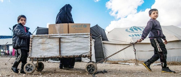 A family receives clothes for the winter from UNICEF in Al-Hol camp in northeastern Syria. — courtesy UNICEF/Delil Souleiman