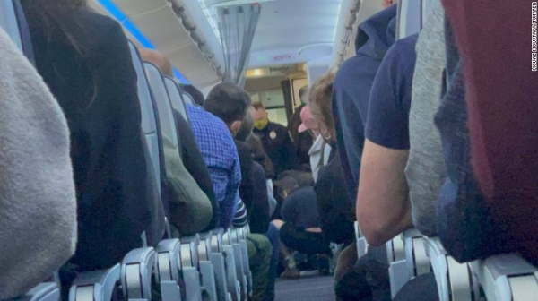 The passenger was reportedly trying to get into the cockpit and open the plane door.