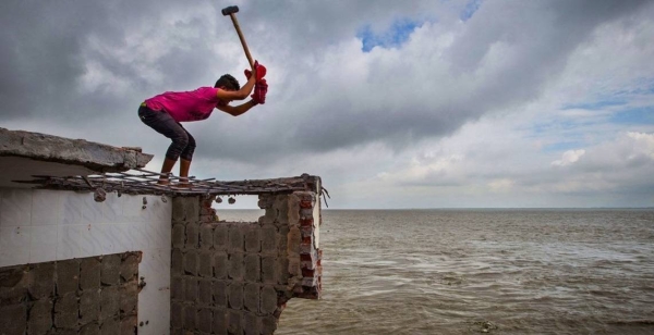 Bricks are salvaged from a home damaged by erosion in Bangladesh.