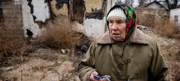 A woman stands in the middle of what used to be her rose garden in Ukraine. (file)