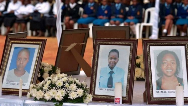 People attend the requiem mass for nine young girls who died in the Moi Girls School dormitory fire.