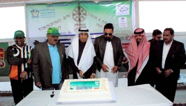 Saadi Ali Habeeb Aal Quraish (middle), Farhat Mahmoud (left) and EPCA officials performing the Saudi Founding Day cake cutting ceremony at the ground.