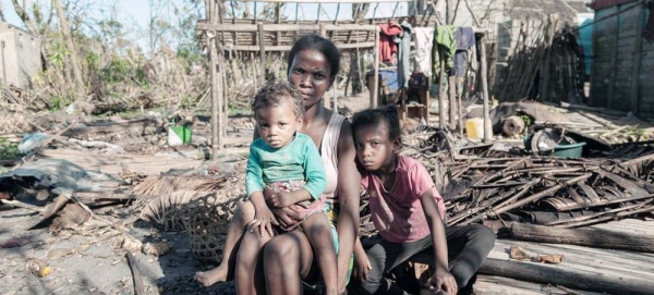 A woman and her two young daughters sit next to what is left of their house in the aftermath of Cyclone Batsirai in Madagascar. — courtesy WFP