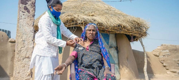 An elderly woman receives a second dose of the COVID vaccine during a door-to-door campaign in a village in Rajasthan, India. — courtesy UNICEF/Vinay Panjwani
