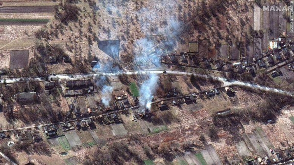 The Russian convoy is seen along with smoke rising from what appears to be burning homes, northwest of Invankiv, Ukraine.