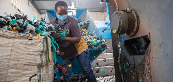 A worker sorts plastic for recycling at Dandora landfill in Nairobi, Kenya.