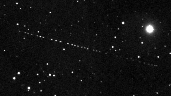 The rocket booster can be seen tracking across the sky right-to-left.