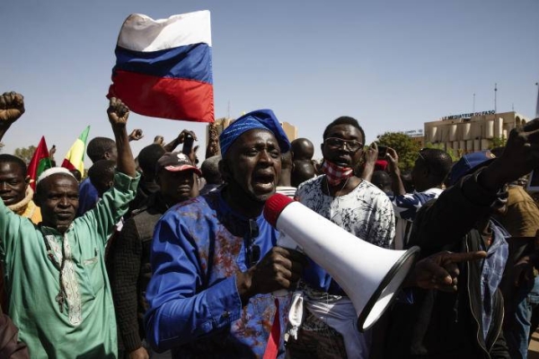 The Russian flag is carried in a crowd in the national plaza in Ouagadougou, the capitol of Burkina Faso, the day after a military coup, Jan. 25, 2022. 