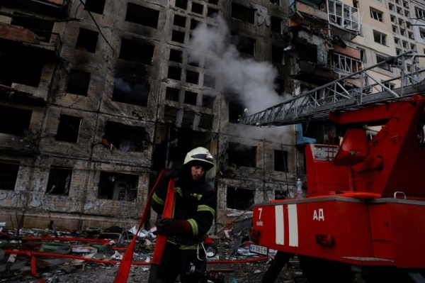 A Ukrainian firefighter works at an apartment building after it was hit by artillery shelling in Kyiv, Ukraine, on March 14.