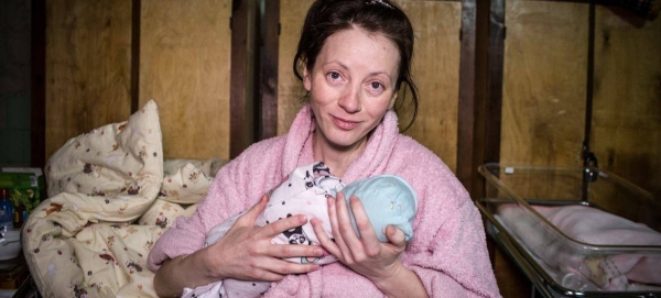 A woman holds her newborn baby in a makeshift ward at a perinatal centre in Kyiv, Ukraine.
