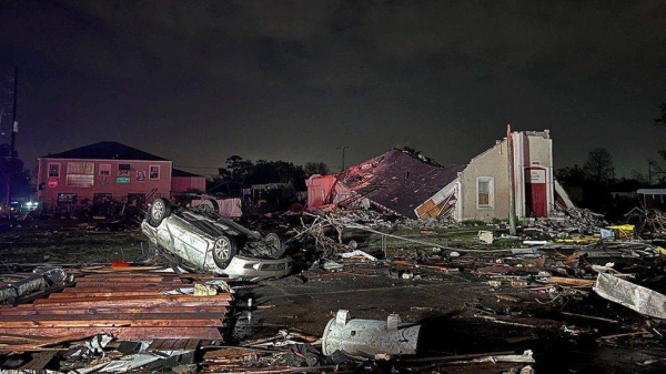 The tornado overturned cars and tore off rooftops.