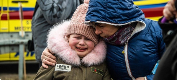 Families arrive in Berdyszcze, Poland, after crossing the border from Ukraine, fleeing escalating conflict.