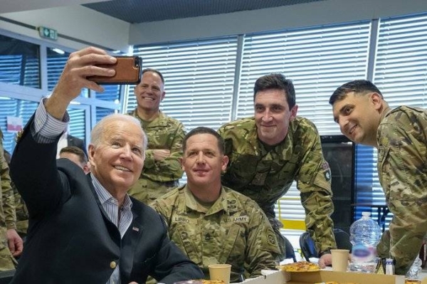 US President Joe Biden is seen taking a selfie with members of the 82nd Airborne Division on the ground in Poland. The 82nd are serving alongside Polish military to bolster NATO’s frontline defenses.