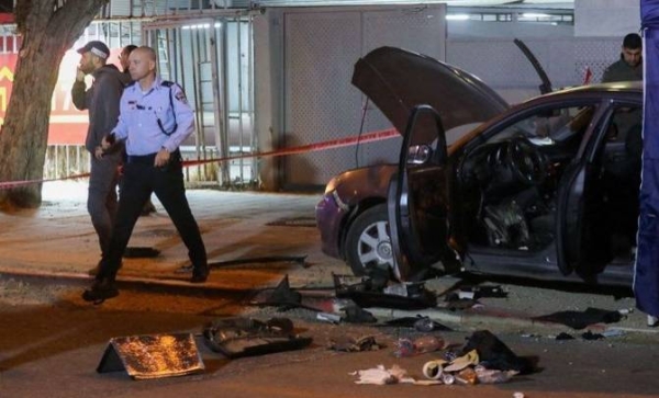 Israeli security forces gather at the site of an attack that left two people dead in the northern city of Hadera.