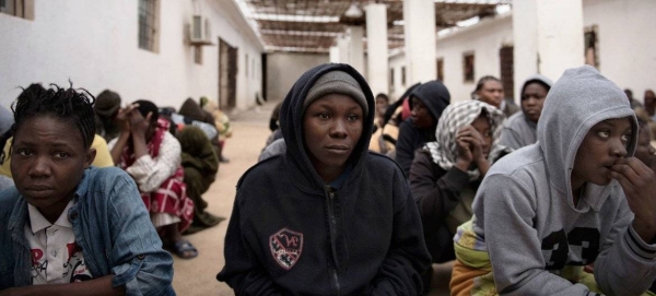 Migrants from Nigeria who were rescued by the Libyan Coast Guard as their boat was capsizing, crouch in a courtyard at a detention center, where they are being held, in Libya. (file)