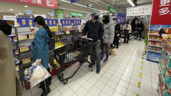 Lockdown restrictions in Shanghai have resulted in residents thronging supermarkets to stock up on essential supplies.