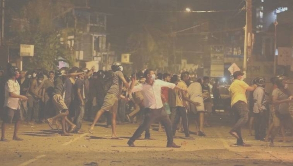 People clash with the police during a protest against the current economic crisis, outside the President