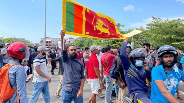 A protester holds up the Sri Lanka flag amid a crowd of demonstrators in Colombo.