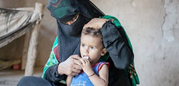 A woman sits with her son at the family's makeshift home in Lahj, Yemen. — courtesy WFP/Hebatallah Munassar