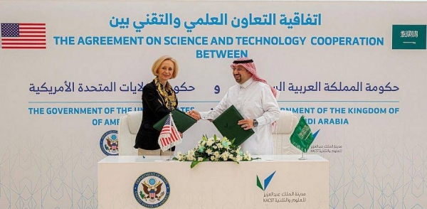 KACST President Dr. Munir El-Desouki and US Chargé d'Affaires Martina exchange documents after signing the protocol.