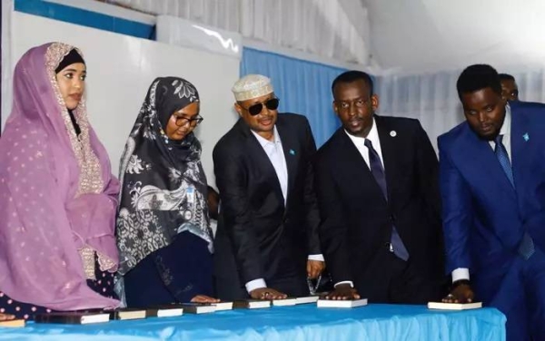 Newly sworn-in legislators take the oath during a swearing-in ceremony in Mogadishu's heavily protected airport.